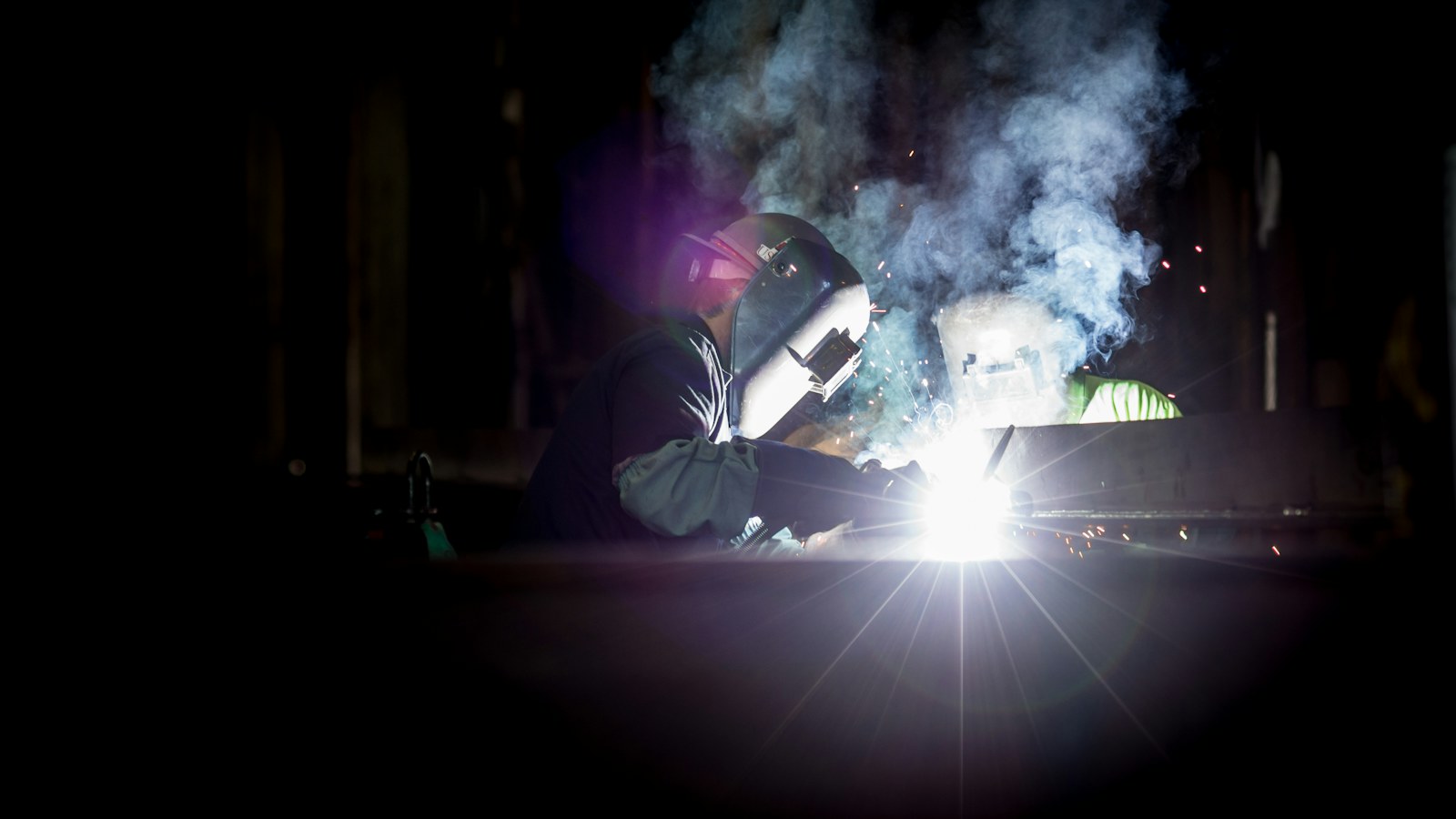Illustrative welder with visor and gloves